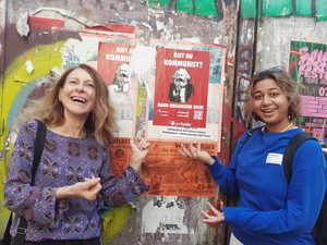 Faculty and student look at murals in Berlin