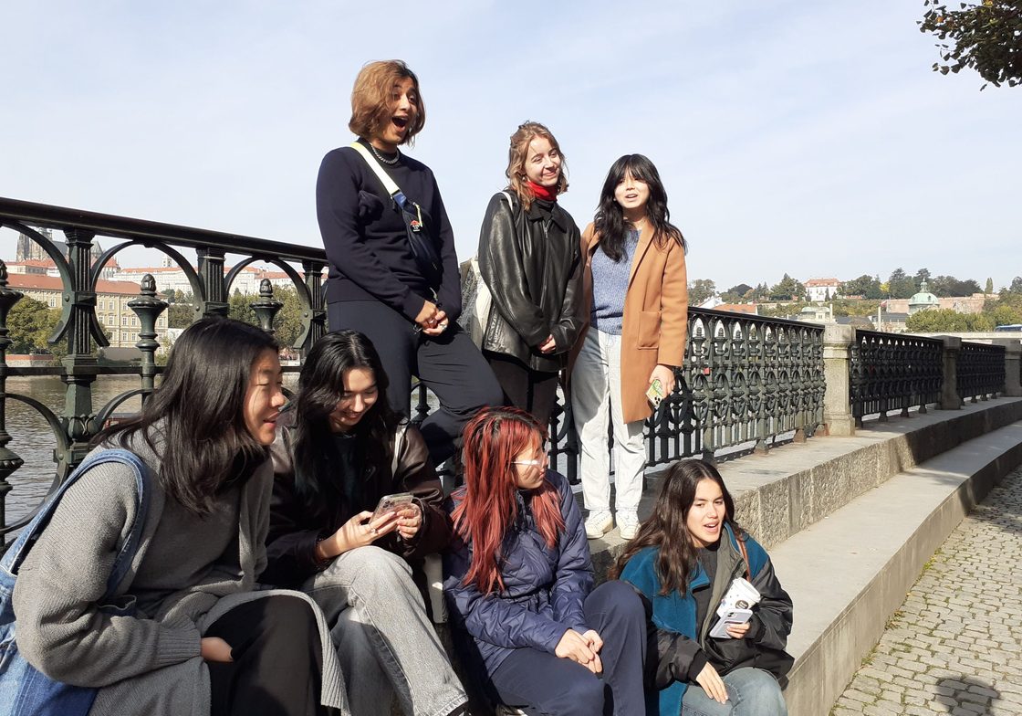 Students relax on a bridge in Prague