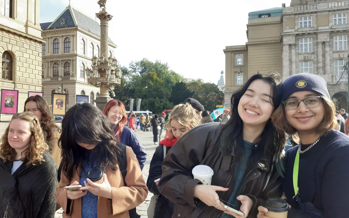 Student enjoy a coffee while walking Prague