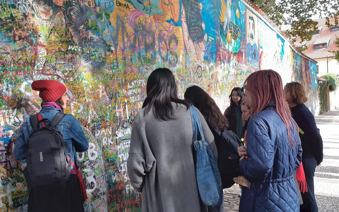 Students look at mural wall in Prague