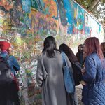 Students look at mural wall in Prague
