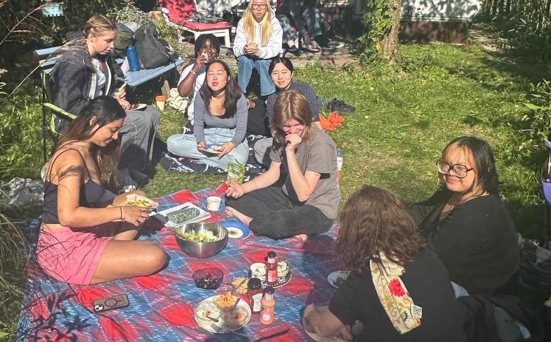 Students enjoy a picnic in the woods