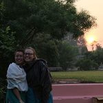 Two students smile as the sun sets