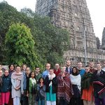 Entire group poses in front of temple