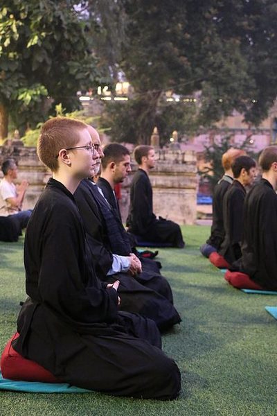 Students meditate outdoors