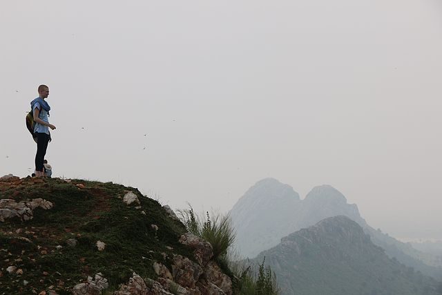 A student stands at the edge of a mountain