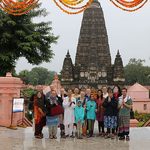 The program group poses in front of the temple