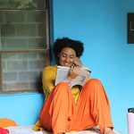 A woman smiles as she reads a book