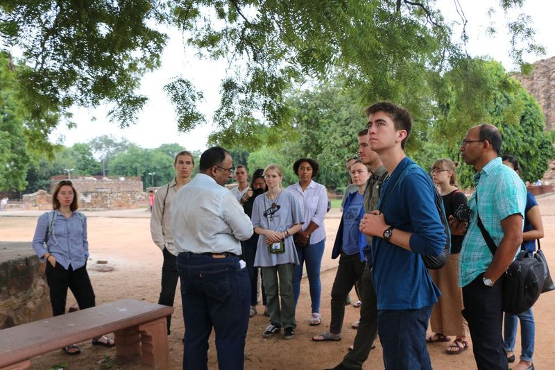 Students listen to a lecture while on a site visit.