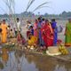 Indian women gather near the water