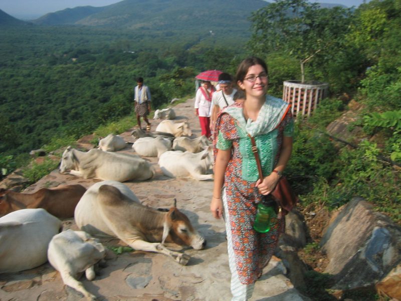 A student smiles as she marches past sleeping animals.