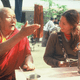 A student smiles as a Geshe talks expressively