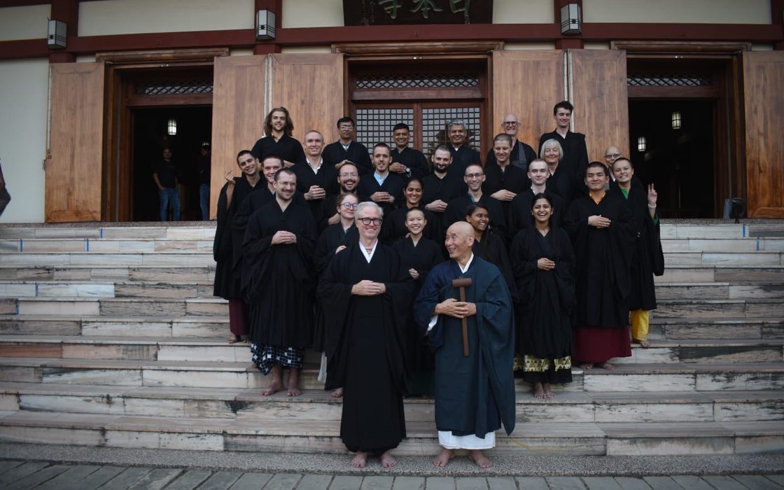 Students and staff with Ekai Korematsu Roshi and Arthur McKeown on the steps of a Buddhist temple