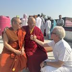 Chokyi Nyima Rinpoche and another Buddhist monk greet Arthur McKeown