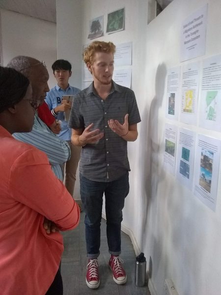 Student presents his independent research project to community members