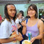 two students outside smiling