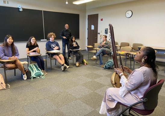 Wassa Kouyate plays a kora for French class