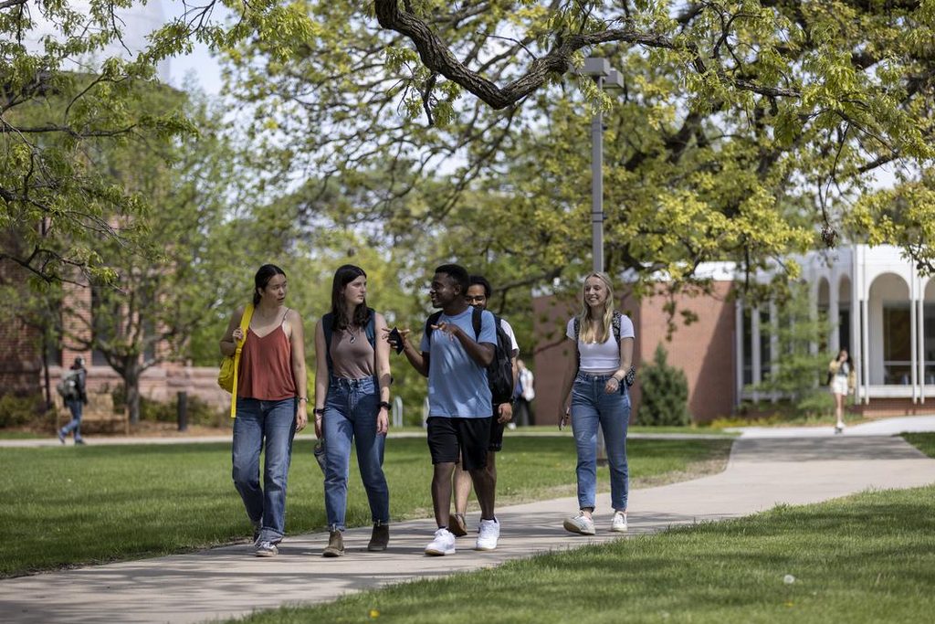students walking outside through Carleton campus