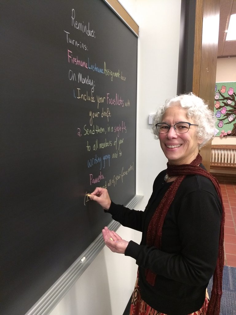 SOAN professor Pamela Feldman-Savelsberg writing on a chalkboard.