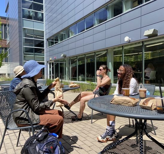 SOAN students and faculty conversing and enjoying food on the Weitz patio at the spring '24 New Majors Gathering.