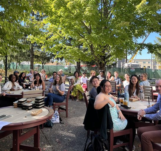 SOAN students and faculty posing for a group photo on the AGH patio at the fall '24 Welcome Back Lunch.