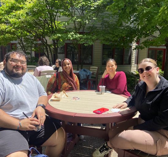 A group of SOAN students and faculty enjoying banh mi and bubble tea on the AGH patio at the spring '25 New Majors Gathering.