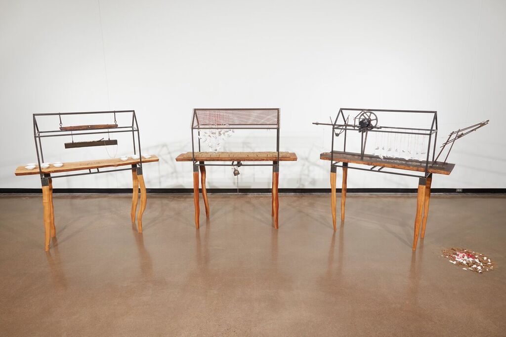 Boxes on wooden tables containing various objects
