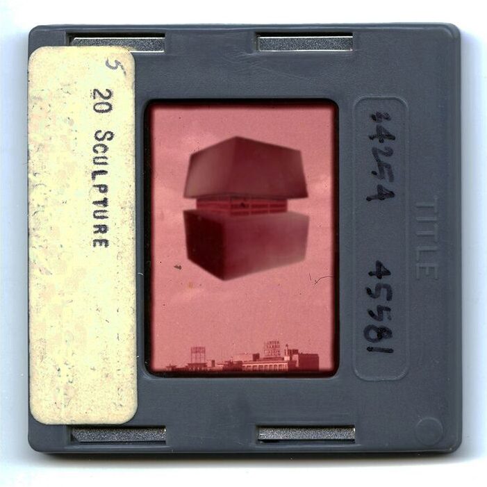 Digital print of a vintage color slide showing a large steel object hovering in the sky