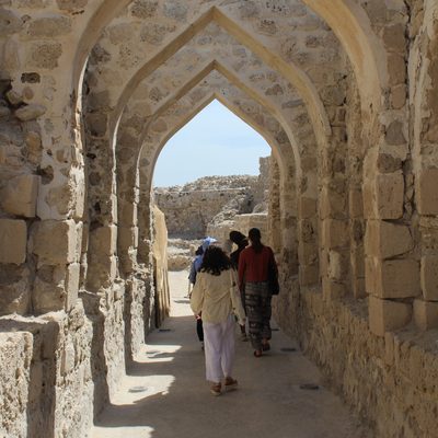 Students Walking Beneath Stone Archway Africa & Arabia