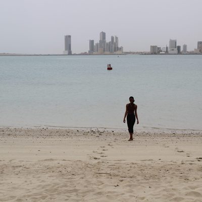 People on Beach with City Skyline in Background Africa & Arabia