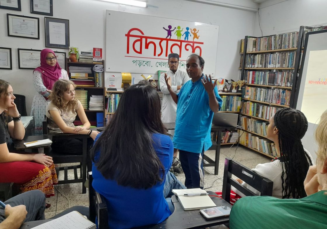 teacher speaking to students in classroom