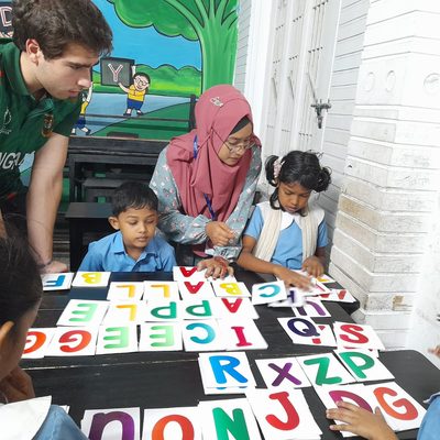 students teaching children