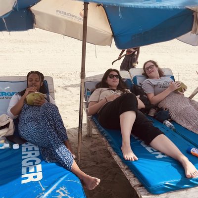 students laying on beach