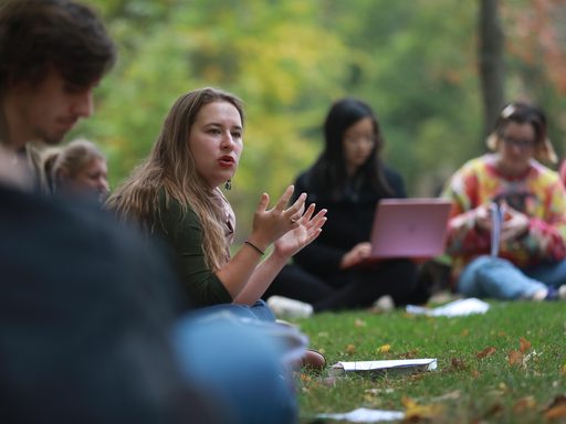 Faculty and students meet for an outdoor class discussion