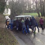 The class pushes a stranded family out of the flooded river.