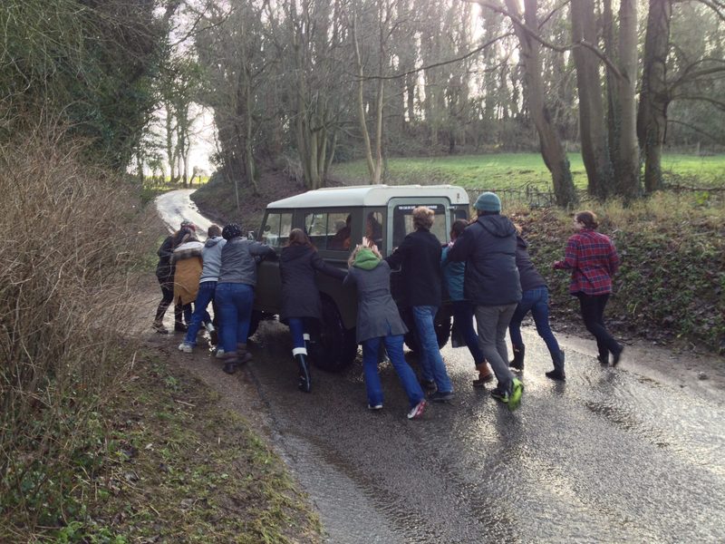 The class pushes a stranded family out of the flooded river.