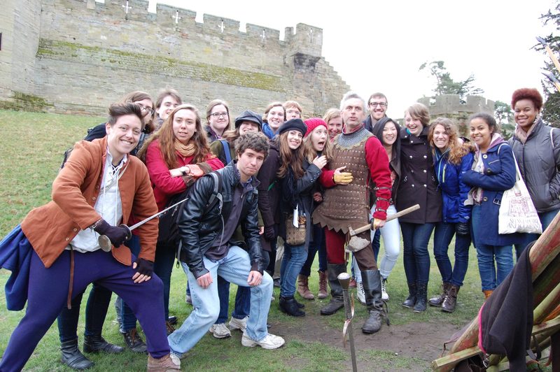 The group posing with the longbow demonstrator at Warwick Castle