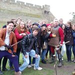 The group posing with the longbow demonstrator at Warwick Castle