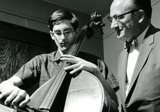 A student receives bass lessons from instructor Kenneth Davenport at the music hall in 1964.