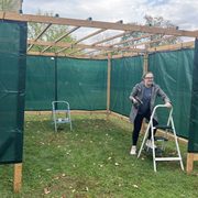 One person works to build a sukkah structure outside Skinner Chapel.