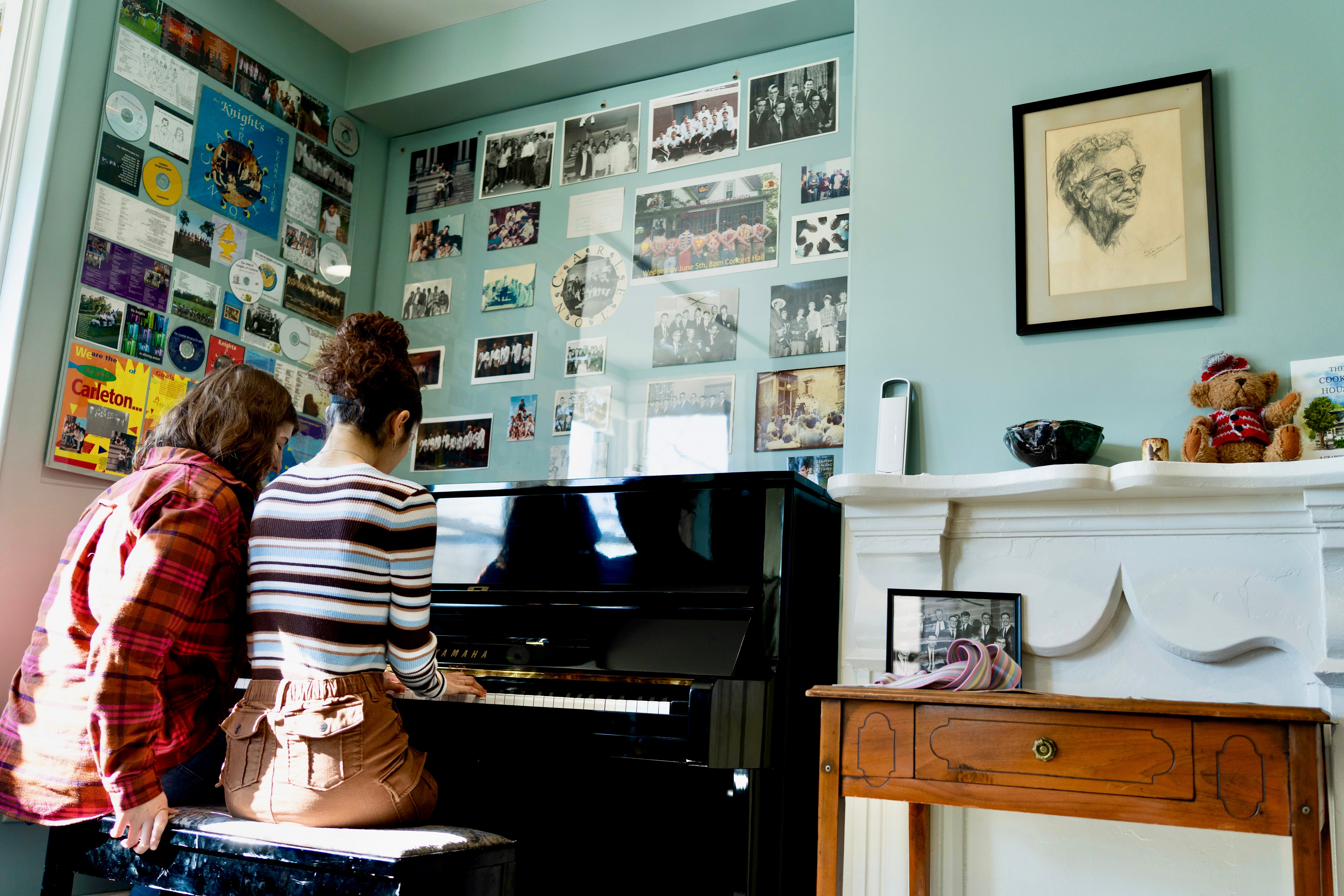 Students playing the piano during brunch at Dacie Moses House