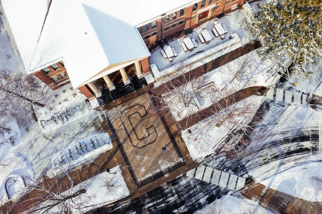 winter aerial view of Carleton "C" and snowy sidewalks outside Sayles