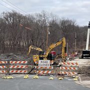 Excavators and road blockers signal road construction on Wall Street Road