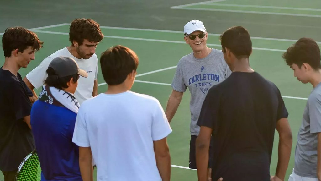 tennis team gathers on court