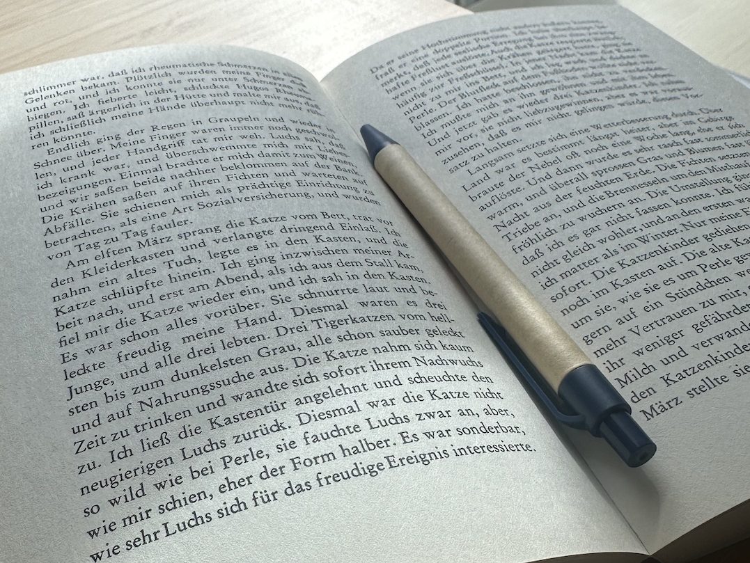 book open with a pen