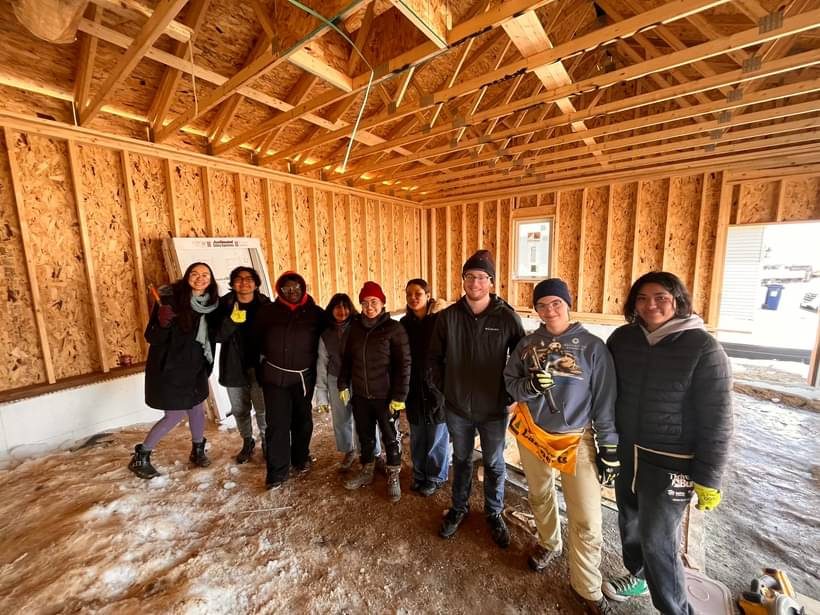 Place Based Justice Group at Habitat for Humanity working in a closed in home