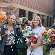 Organizers of Runway Revival with recycled homemade paper flowers
