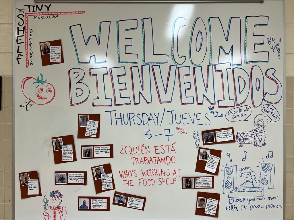 Whiteboard with Spanish and English writing Welcome at the Northfield Community Education Center (NCEC) Food Shelf