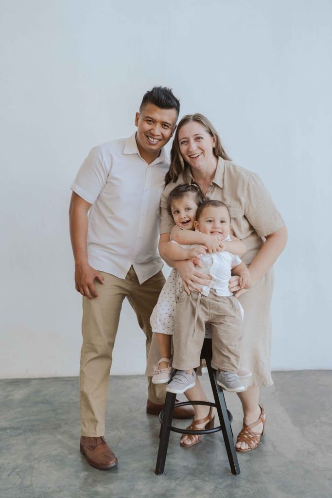 Sarah Prather ’11 posing with her husband and two young children