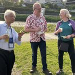 Several people standing outside socializing